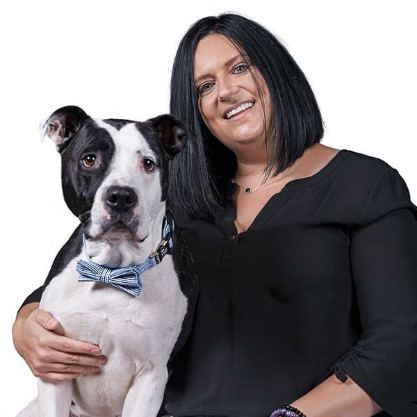Emergency Medicine Veterinarian Medical Director of MedVet Northern Utah, Dr. Holly Dougherty, holding her black and white pet dog