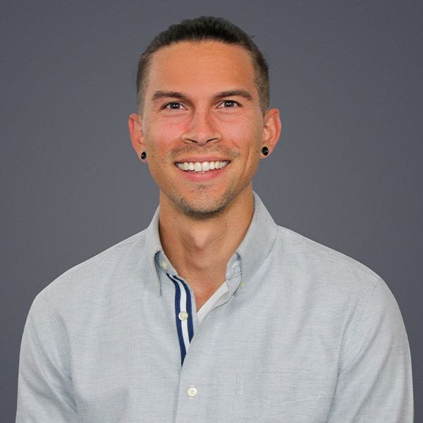 Hospital Director, Sebastian Castro, smiling while facing forward
