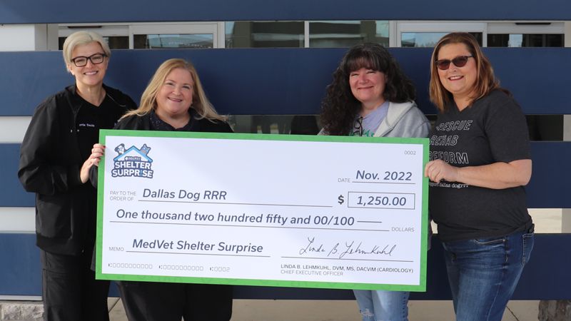 MedVet presents the Shelter Surprise 2nd place winner, Dallas Dogs RRR, with a giant check for $1,250
