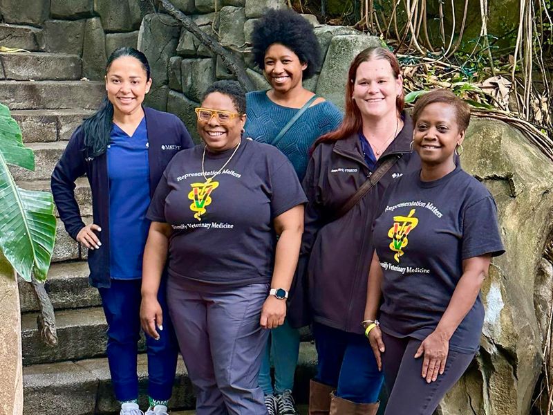 Five members of the MedVet Black Employee Team Network pose for a photo at the zoo