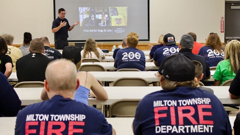 Classroom of fire department first responders receiving CPR training for pets