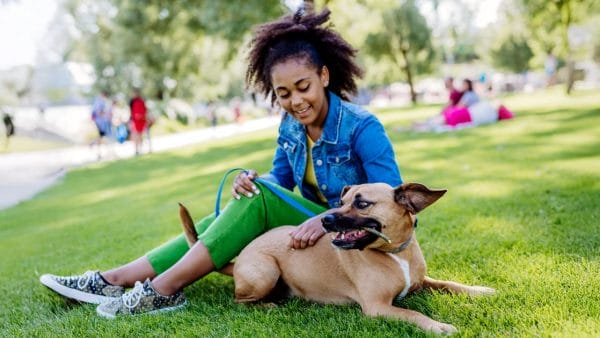 Attentive-Dog-Owner-Resting-With-Her-Dog